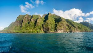 Ke'e beach on Na Pali coastline in Kauai from sunset cruise