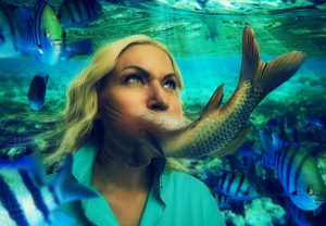 Woman's face smoothly changing to fishtail under the water