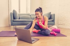 Attractive Woman On Laptop In Virtual Online Fitness Class Worki