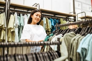 Woman choosing clothes in clothing store