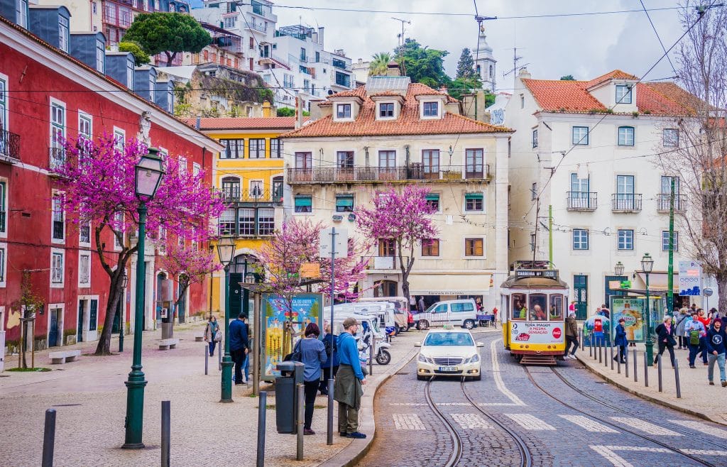 A typical old yellow vintage tram 28 on the street of Lisbon, Portugal