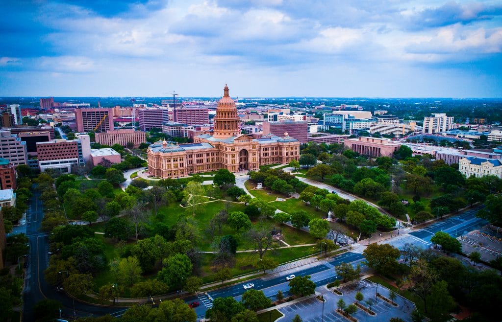 Sunset at the Texas State Capitol building in Austin Texas USA aerial drone views of the capital cities government political building surrounded by green space on a perfect evening sunset