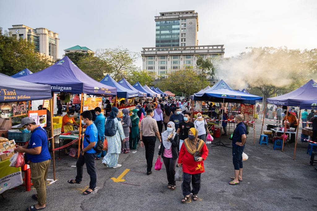 Kuala Lumpur, Malaysia - September 13, 2021: The fresh market in Putrajaya, near the capital Kuala Lumpur, is busy. Face masks are compulsory during the Covid-19 restrictions. People carry their purchases