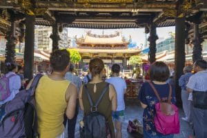 Taipei, Taiwan - Aug 7, 2018 : Crowd of people make a pray at Longshan Temple in Taipei, Taiwan on August 7, 2018.