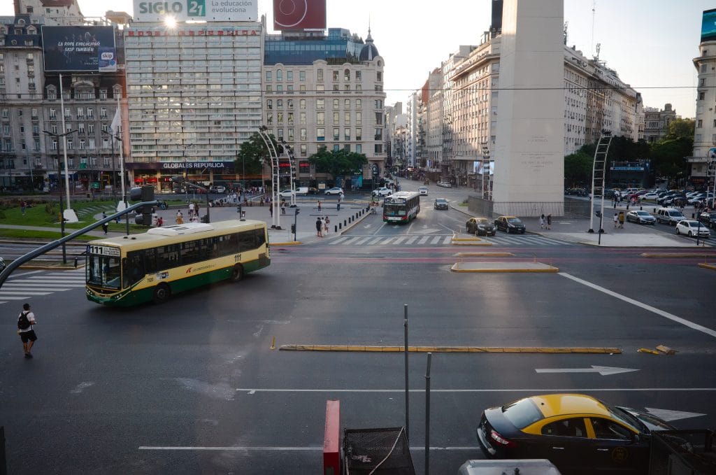 Buenos Aires, Argentina - January, 2020: Plaza de la Republica view with Obelisco de Buenos Aires. Traffic with public buses and cars on Republic Square in capital of Argentina