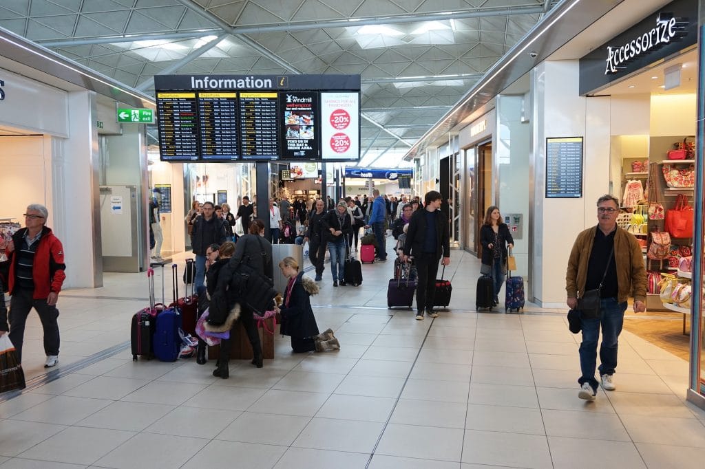LONDON, UK - APRIL 24, 2016: People visit duty free shops in London Stansted Airport, UK. With 22.5 million passengers in 2015 Stansted was the 4th busiest airport in the UK.