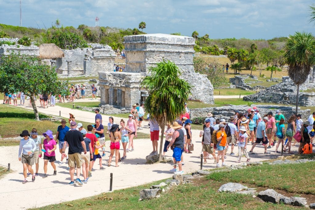 TULUM,MEXICO - APRIL 18,2019 : Visitors at the ancient mayan ruins of Tulum in Mexico