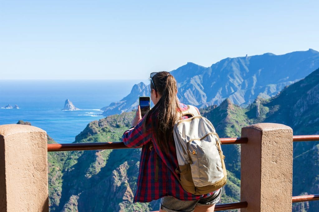 Woman hiker watching beautiful costal scenery. - Tenerife, Canary Islands, Spain. coast view, mountain Anaga
