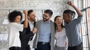 Excited multiethnic businesspeople celebrate shared business success