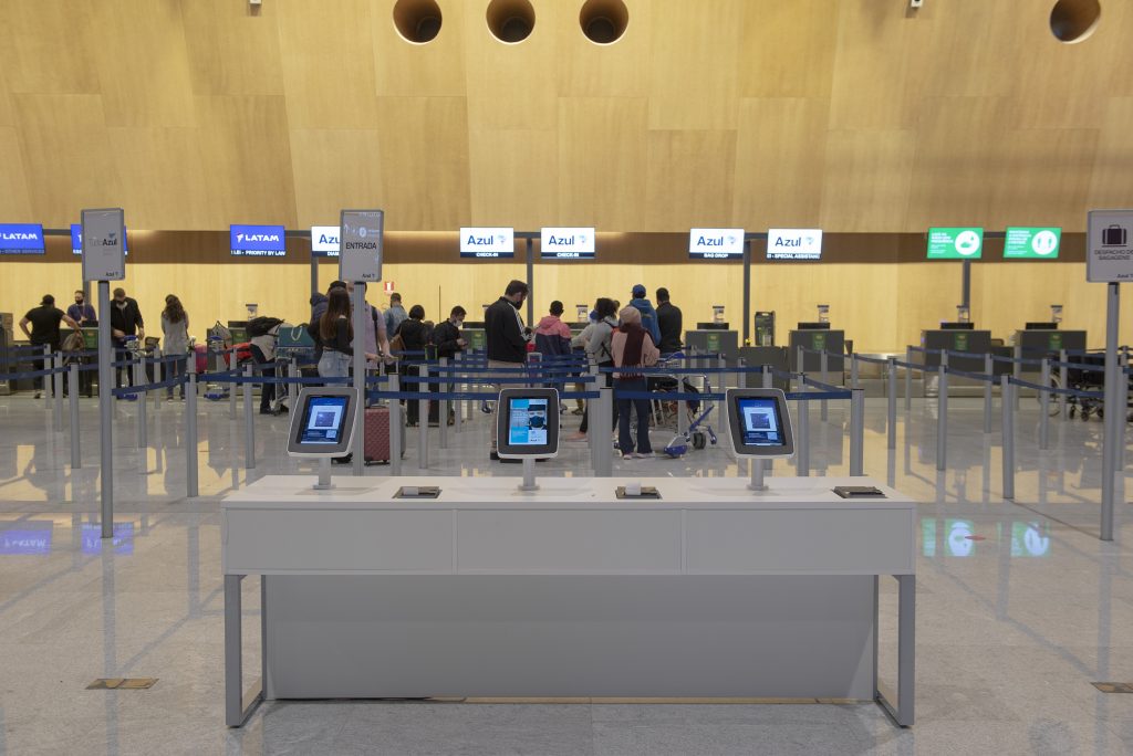 Florianopolis, Brazil. 15/09/2020: Tablet available for airport check-in. Important to avoid queues in a pandemic period. Queue on background. Selective focus.