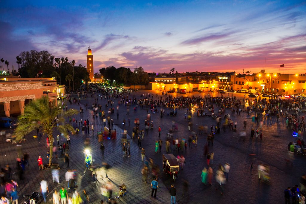 MARRAKECH, MOROCCO - APR 29, 2016: Sunset view on the Koutoubia mosque and Djemaa el Fna square with people in Marrakesh.