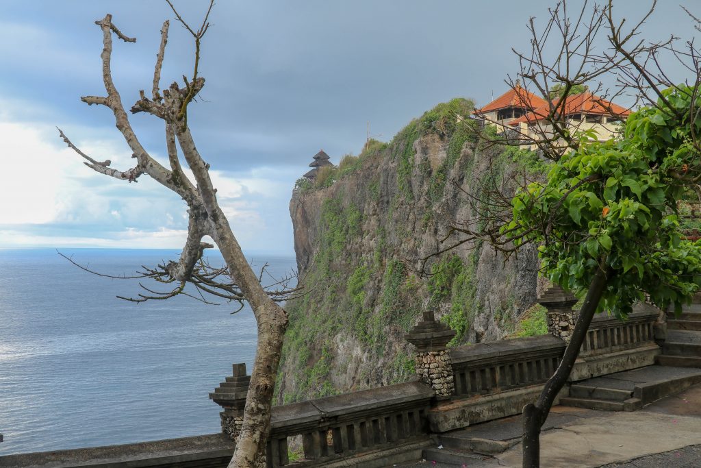 View of Uluwatu cliff with pavilion and blue sea in Bali