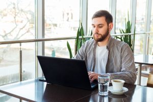caucasian man sitting at table in cafe,