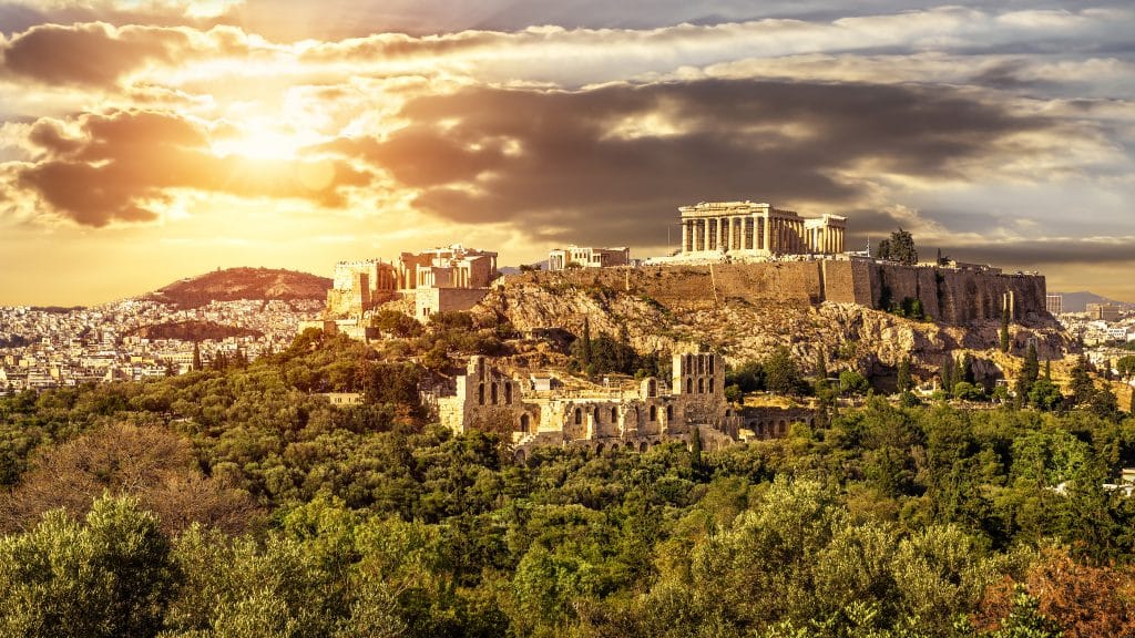 Acropolis of Athens at sunset, Greece. It is top landmark in Athens. Scenic sunny view of classical Greek ruins in summer, panorama of remains of famous ancient Athens city, beautiful urban landscape