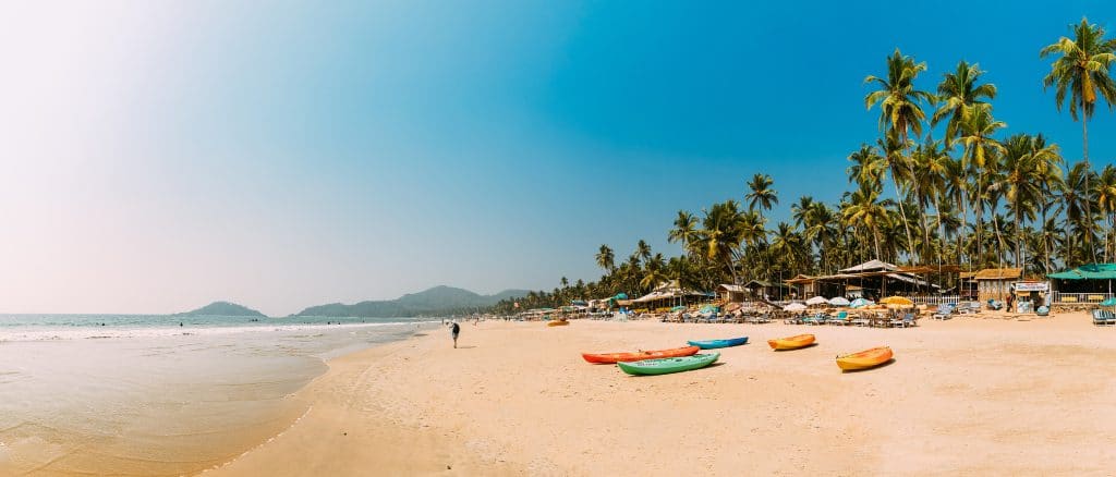 Canacona, Goa, India - February 16, 2020: Canoe Kayak For Rent Parked On Famous Palolem Beach On Background Tall Palm Tree In Summer Sunny Day.