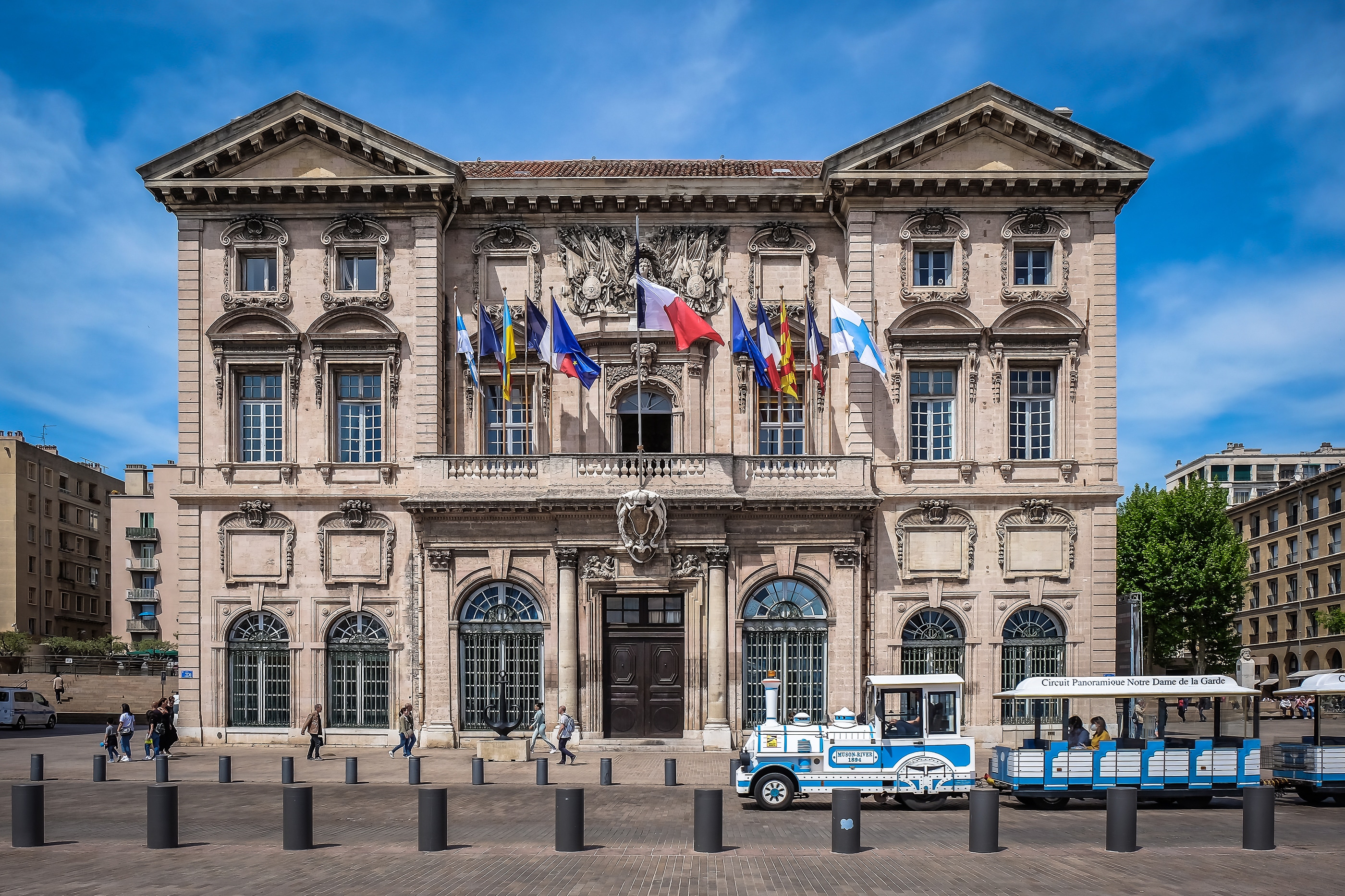Marseille, France, May 2022, view of a mini train passing by the City Hall facade