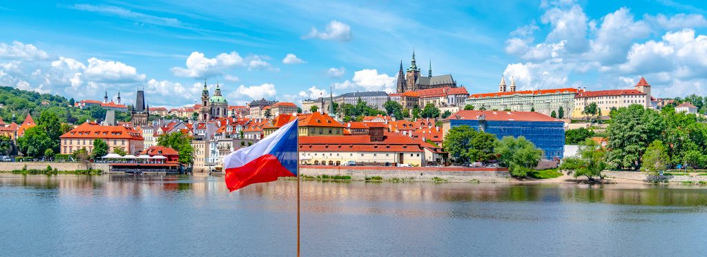 Prague Panorama With Prague Castle And Czech National Flag In Th