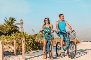 Biking activity couple tourists having fun doing outdoor sport o