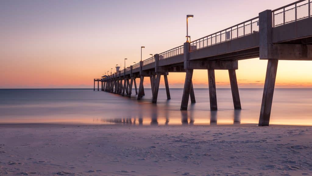 Panorama of Okaloosa fishing pier in Fort Walton Beach, Florida at sunset.