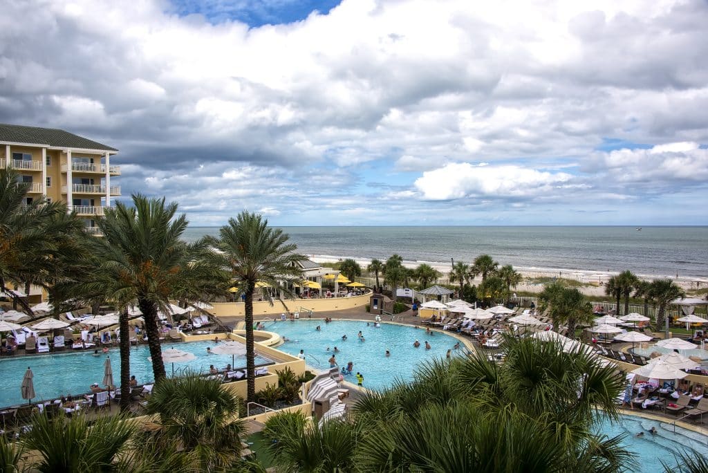 Amelia Island, Florida - August 16, 2019:  Tourists enjoying a day in the pool at a luxury resort hotel on Fernandina Beach on beautiful Amelia Island.