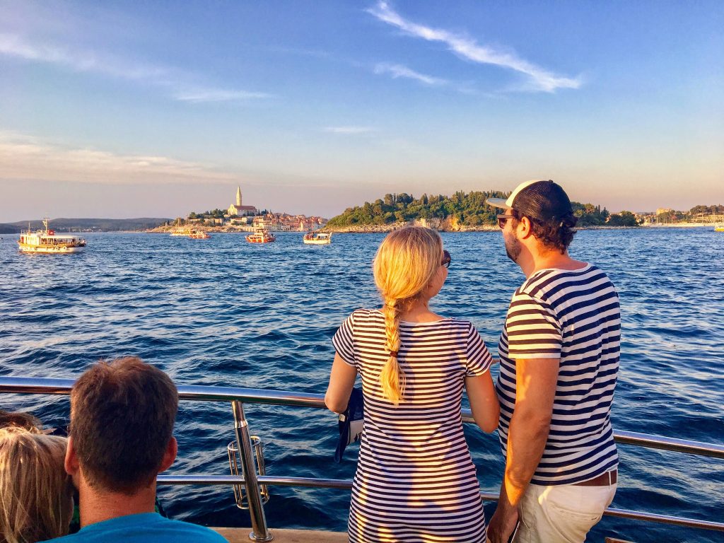 Rovinj, Croatia - July 4th, 2019: A Young Couple Look For Dolphi