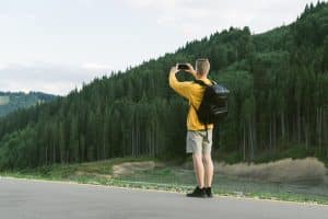 Young male traveler in yellow sweatshirt