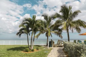 Green beach chairs and blue summer beach house Florida