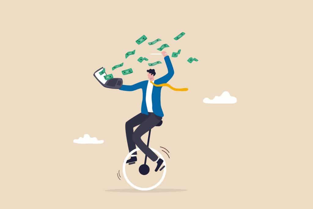 businessman expertise riding unicycle making money from computer laptop